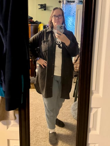 Reviewer taking a mirror selfie wearing the loose Charcoal Long Button Front Cardigan over a t-shirt.
