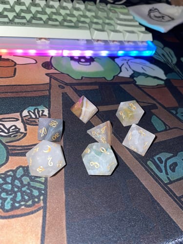 Customer's URWizards D&D Agate dice set showing unique crystal patterns on a desk mat.