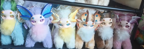 Reviewer's complete set of six colorful, fluffy Cat-Loong Fantasy Magic Academy plushes displayed in a row.