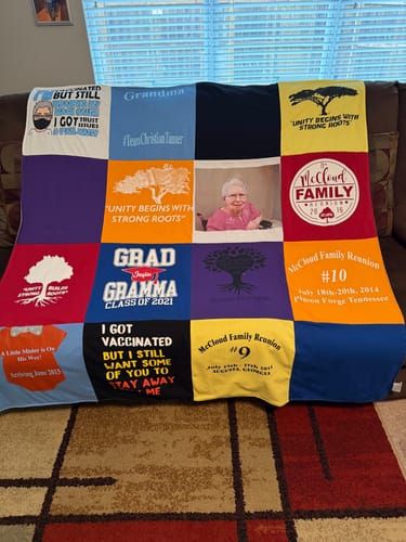 Customer's colorful Premium T Shirt Quilt made from various t-shirts, including one with a photo, draped over a couch.