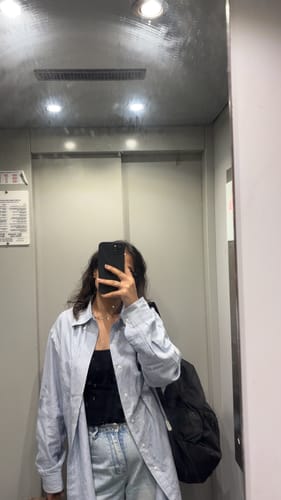 Customer taking a mirror selfie with their black Anti Dust Magsafe Silicone Case on an iPhone.