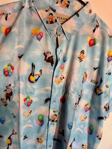 Customer's close-up of the light blue Disney and Pixar Up shirt with its colorful character and balloon print.