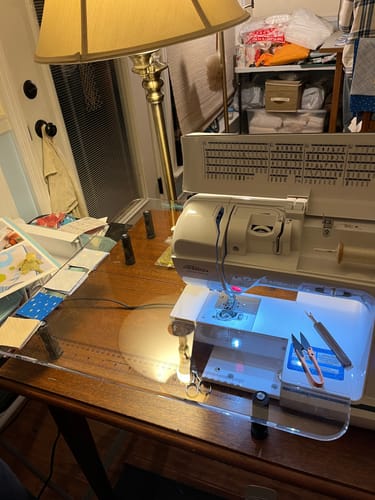 Customer's clear Sew Steady Sewing Machine Extension Table fitted to a sewing machine with small quilting squares on top.