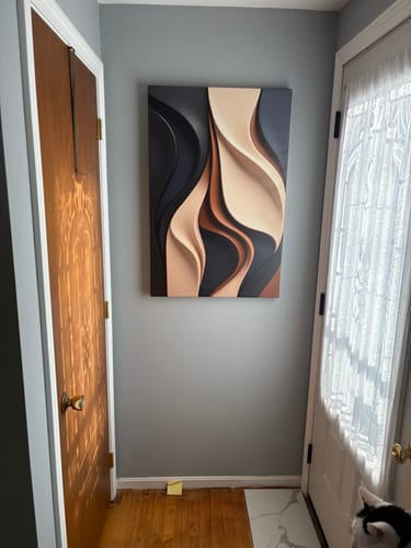 Customer's abstract minimalist wall art with flowing shapes, hung on a gray wall in a hallway.