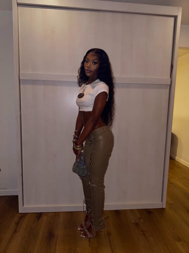 Customer standing sideways to show the full-length fit of the tan, low-rise Vice Pant.