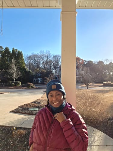 Reviewer wearing the blue Neck Gaiter and matching beanie outdoors.