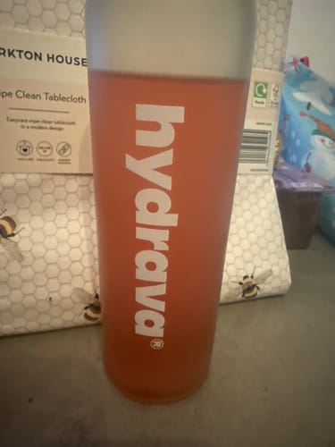 Customer's branded hydrava shaker cup filled with a pink electrolyte drink.
