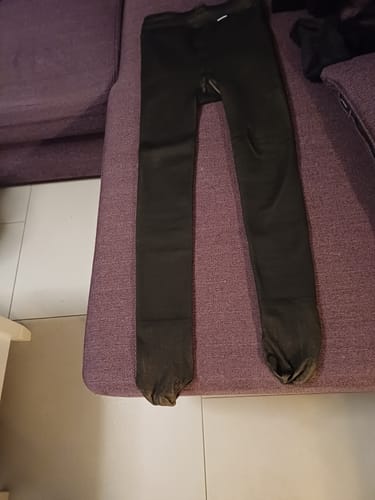 Le collant polaire noir d'une cliente, posé à plat sur un canapé pour montrer sa longueur.
