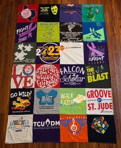 Customer's Premium T Shirt Quilt made from their son's memory t-shirts, laid out flat to show the colorful squares.