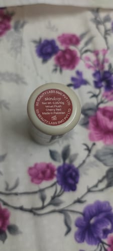 Close-up: The bottom of the customer's VELVET FLUSH blush stick showing the product information label.