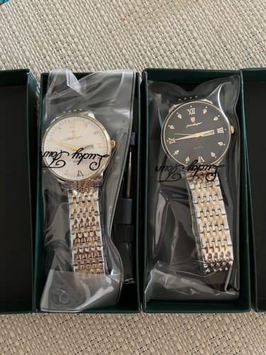 Reviewer's two Lucky Fours® Nassau watches, one with a white dial and one with a black dial, in their original packaging.