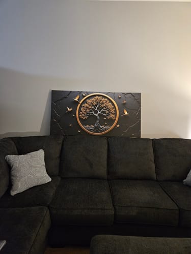 Customer's 3D Celtic Tree of Life Wall Art hanging on a wall above a dark sectional sofa.