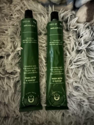 Customer's two tubes of Radiating Cream with Jícama & Aloe Vera on a fluffy surface.