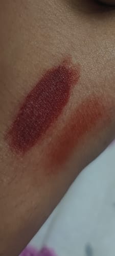 Customer swatches the VELVET FLUSH blush on their arm, showing a light orange shade and a darker maroon shade.