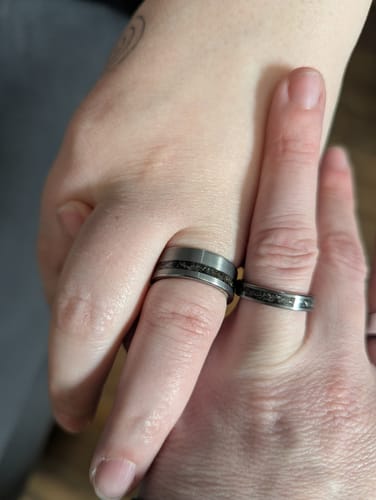 Customer's hands showing their matching Thor Set rings, featuring a brushed finish and dark meteorite inlay.