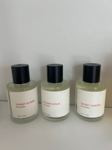 Customer's Golden Hour perfume bottle sits on a shelf between two other fragrances.