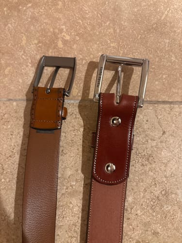 Customer's Canyon belt on the right compared to another belt, showing its longer, thicker leather section near the buckle.