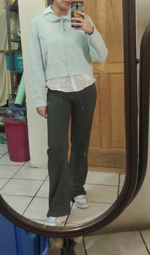 Reviewer in a full-length mirror selfie wearing the light blue Crochet Floral Applique Knitted Cardigan over a white shirt.