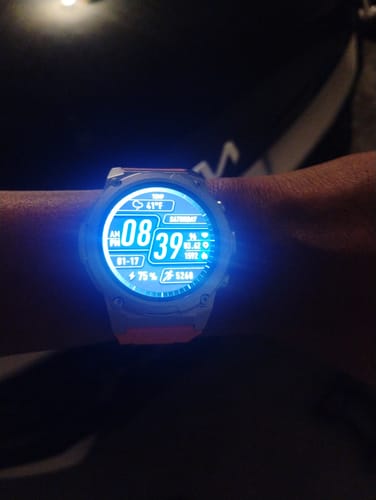 Reviewer's Gard Pro Ultra 3 watch on their wrist, with the bright digital face illuminated in the dark.