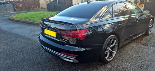 Customer's shiny black car showing a glossy finish after being detailed with the Apex Warrior Kit.