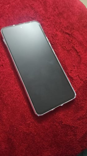 Customer's One Plus Nord 4 in the clear case, showing the front of the phone on a red surface.