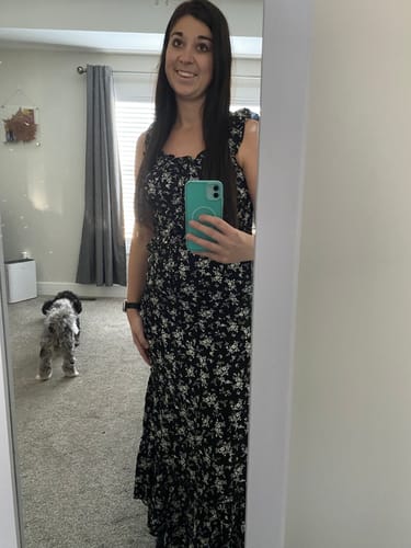 Reviewer in a mirror selfie wearing the floral So In Love Skirt with the matching top.