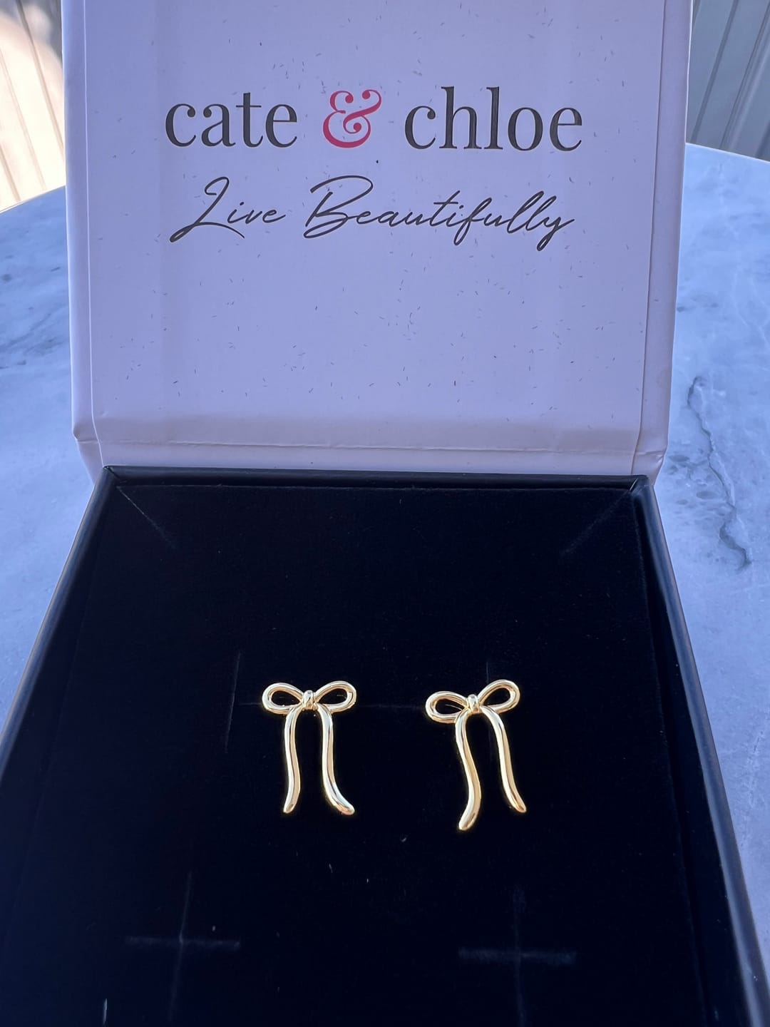 Customer photo review of Lola 18k White Gold Plated Ribbon/Bow Drop Earrings