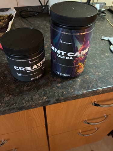 Customer's tub of Complex Joint Care Ultra on a kitchen counter next to a smaller tub of creatine.