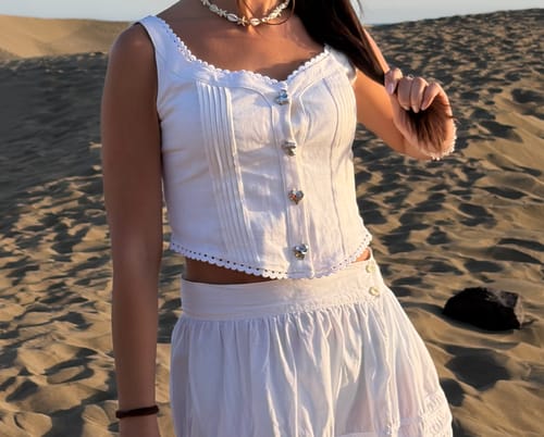 Reviewer wearing the white Lace Trim Cami Top, showing the pintuck details and heart-shaped buttons.