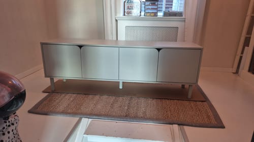 Recensent toont het kasjmierkleurige Husk tv-meubel, opgesteld in een licht interieur.