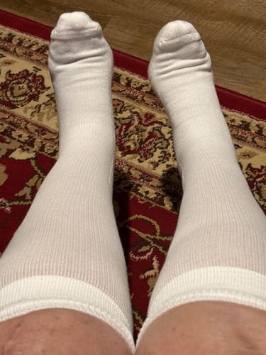 Reviewer's legs wearing the white Performance Eucalyptus Compression Socks, showing the fit on the calves.