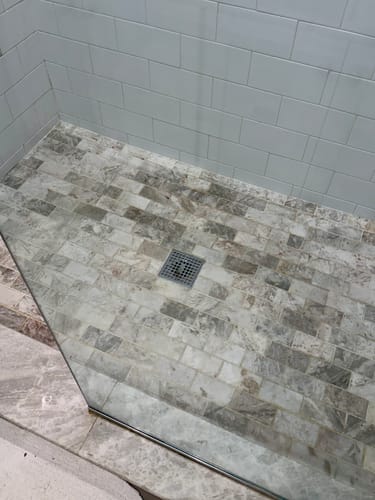 Customer's clean glass shower door and tiled floor after using the Glass & Window Concentrate.