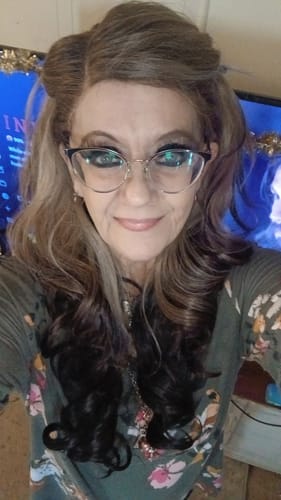 Reviewer wearing the Outre Melted Hairline wig with a long, wavy style.