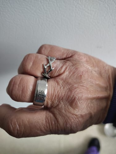 Reviewer wearing the silver Crown of Thorns Ring on their finger, shown above another plain band.