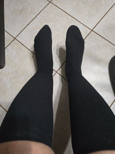 Customer wearing the black Performance Eucalyptus Compression Socks, seen from their point of view.