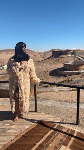 Customer standing on a deck in a full-length view of the open-front Knit Shaggy Loop Coat.