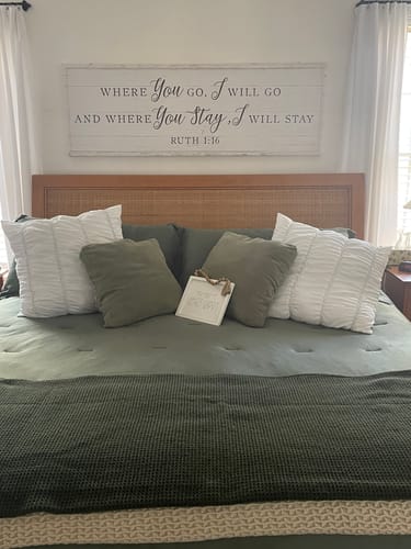 Customer's long, white Tailored Boost canvas with a quote hanging on the wall above a bed.