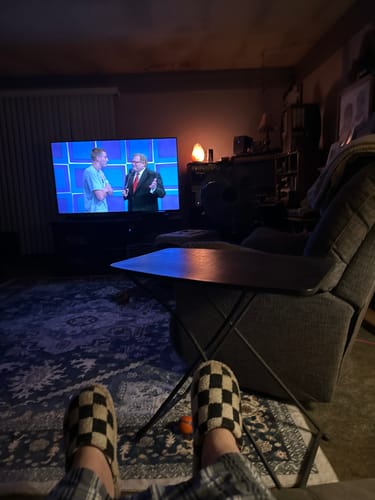 Reviewer's view of their salt lamp glowing warmly in their living room after installing the replacement cord.