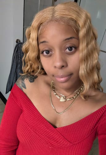 Reviewer showing their styled, blonde Indiremi Lace Front Wig with loose waves.