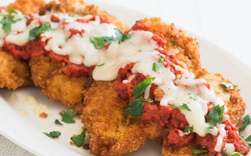 Customer's chicken parmesan dish, made with the Halal Chicken Leg & Thigh, topped with tomato sauce and melted cheese.