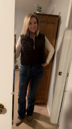 Reviewer showing a full-length view of the dark wash Judy Blue Bootcut Jeans paired with a vest and cowboy boots.