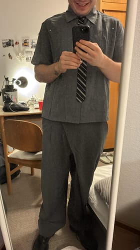 Reviewer wearing the grey short-sleeved shirt with its attached striped tie.