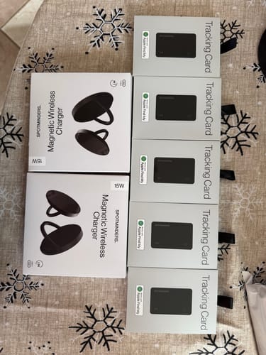 Customer's two SPOTMINDERS Wireless Charger boxes laid out next to several tracking card boxes.