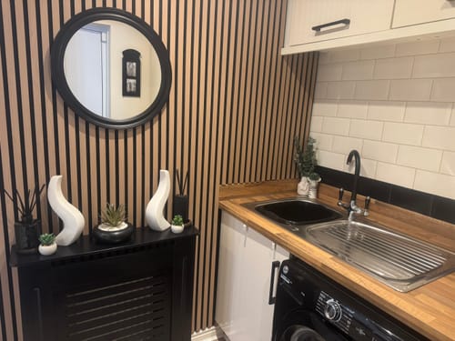 Customer's Premium Acoustic Slatted Wall Panels used as a feature wall in a stylish utility room.