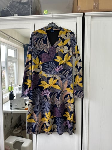 Customer's handmade dress using the Autumn Bouquet jersey fabric, featuring a colorful leaf pattern and long sleeves.