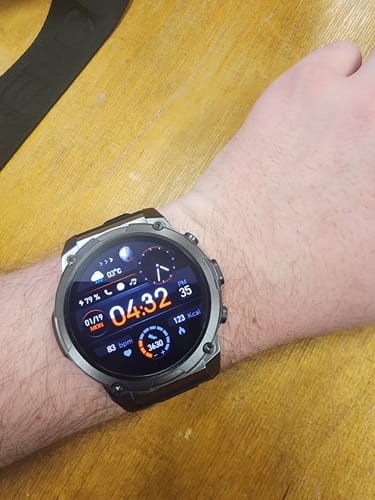 Reviewer's wrist wearing the Gard Pro Ultra 3 smartwatch with its detailed digital face showing time and health metrics.