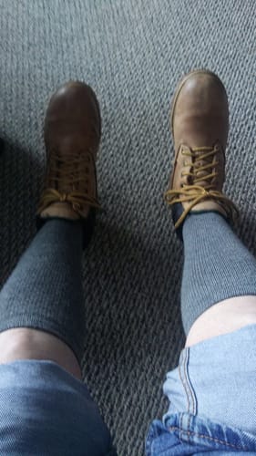 Customer's view while wearing the long, gray Men's Alpaca Socks with brown boots.