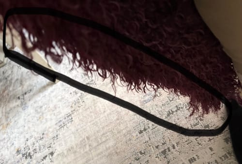 Close-up view of the Faux Fur Plush Long Coat's material, highlighted by the reviewer.