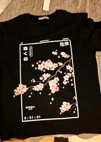 Customer's black Cherry Blossom T-Shirt laid flat, showing the detailed front print.