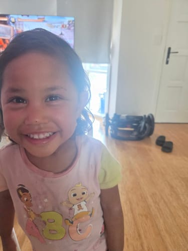 Customer's photo of a smiling child with clear skin after using Hemp Seed Butter.